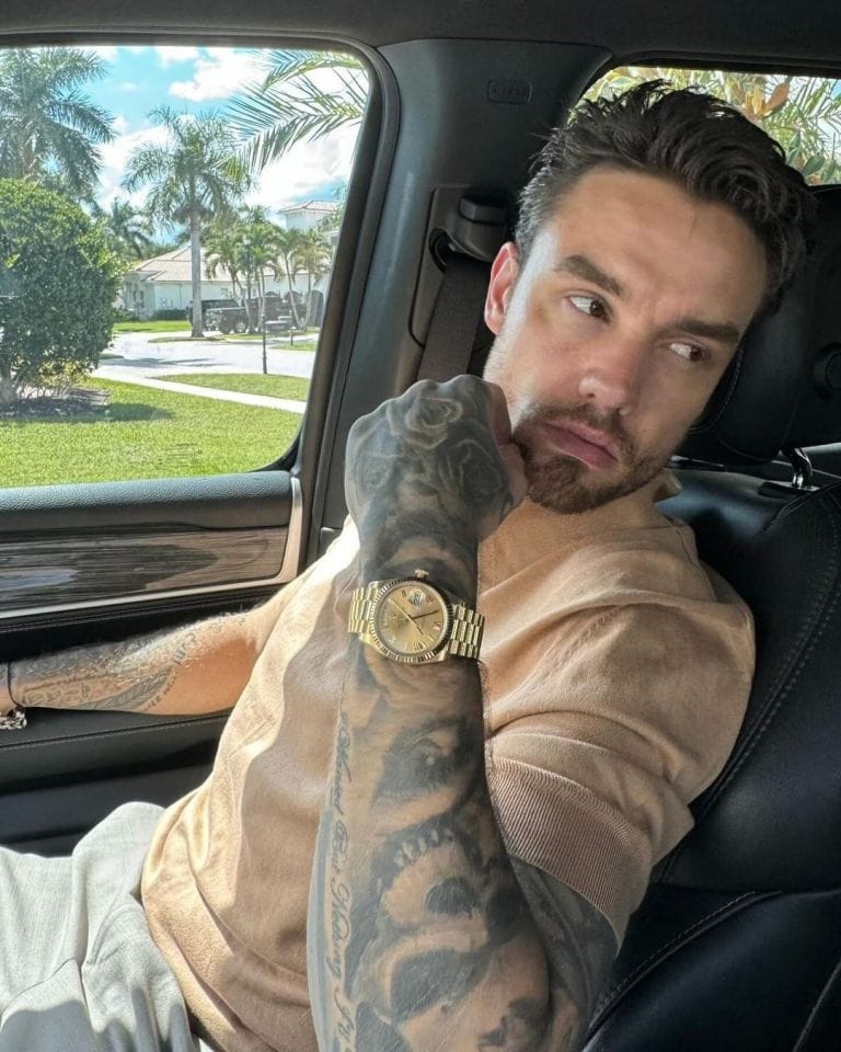 Liam posing in car with Rolex watch on