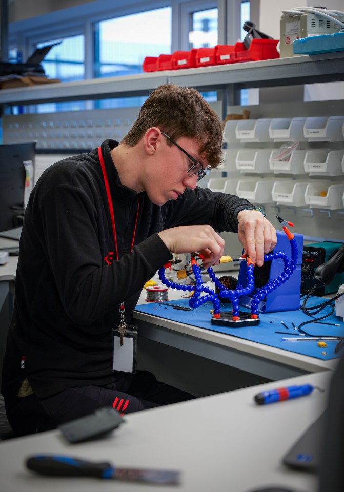 A person soldering electronics.